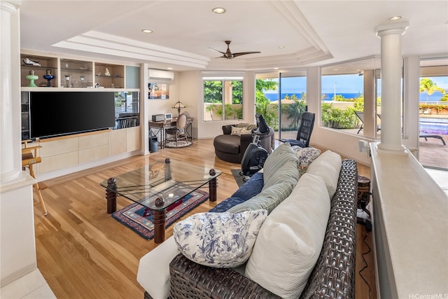 31 Poipu Dr, Honolulu, HI 96825 - living area featuring a tray ceiling, an AC wall unit, ceiling fan, and decorative columns