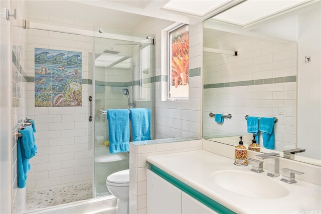 31 Poipu Dr, Honolulu, HI 96825 - bathroom with toilet, tile walls, vanity, and a stall shower