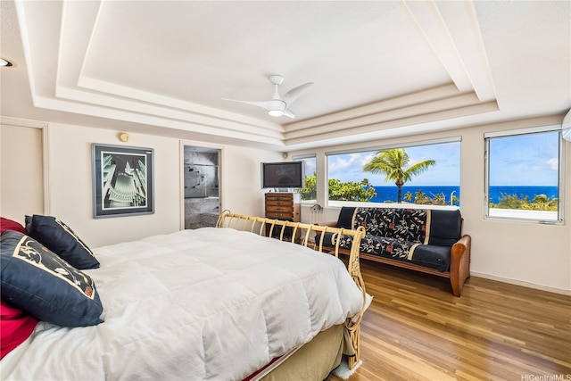 31 Poipu Dr, Honolulu, HI 96825 - bedroom with a tray ceiling, light wood-style flooring, and baseboards