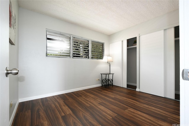 98-719 Iho Pl Unit 5/804, Aiea, HI 96701 - unfurnished bedroom with two closets, wood finished floors, and a textured ceiling