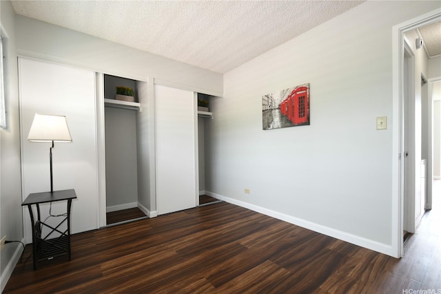 98-719 Iho Pl Unit 5/804, Aiea, HI 96701 - unfurnished bedroom featuring dark wood finished floors, a textured ceiling, attic access, and multiple closets