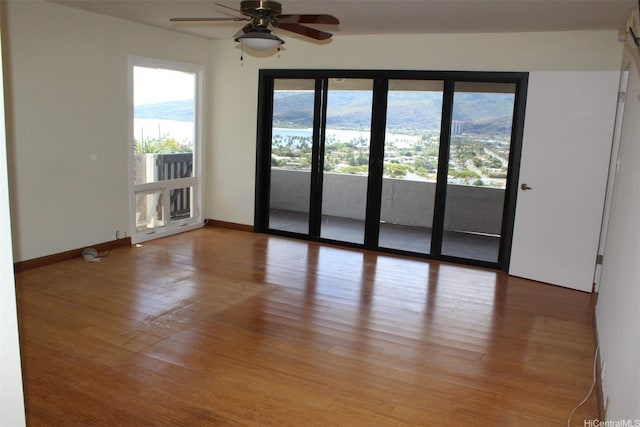 155 Polihale Pl, Honolulu, HI 96825 - spare room with light wood-type flooring, a ceiling fan, and baseboards