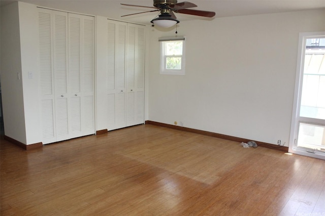 155 Polihale Pl, Honolulu, HI 96825 - unfurnished bedroom with two closets, wood finished floors, baseboards, and ceiling fan
