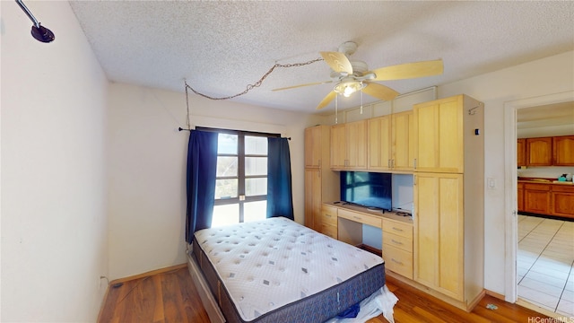 92-1244 Kikaha St Unit 14, Kapolei, HI 96707 - bedroom with a textured ceiling, light wood finished floors, baseboards, and ceiling fan