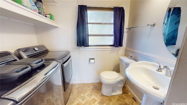 92-1244 Kikaha St Unit 14, Kapolei, HI 96707 - half bath featuring washer and dryer, wainscoting, a sink, toilet, and baseboards