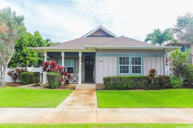 91-1317 Kaiokia St, Ewa Beach, HI 96706 - bungalow-style home featuring a shingled roof, board and batten siding, a porch, and a front yard