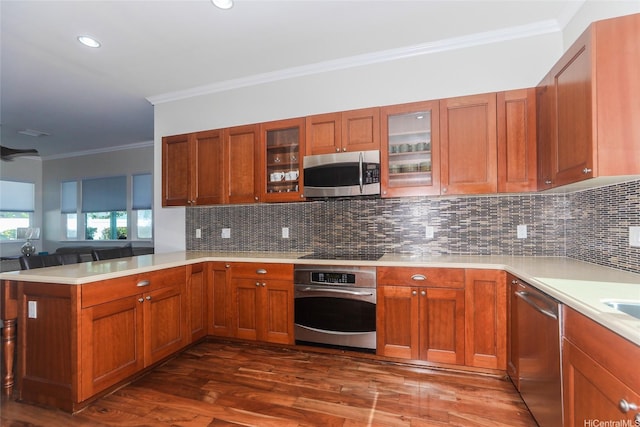 91-1317 Kaiokia St, Ewa Beach, HI 96706 - kitchen featuring crown molding, light countertops, dark wood finished floors, stainless steel appliances, and a peninsula