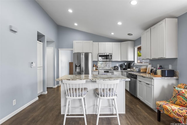 94-1106 Kaloli Loop, Waipahu, HI 96797 - kitchen featuring stainless steel appliances, vaulted ceiling, a kitchen island, dark wood finished floors, and recessed lighting