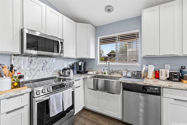 94-1106 Kaloli Loop, Waipahu, HI 96797 - kitchen with stainless steel appliances, white cabinets, dark wood-style flooring, and light stone counters