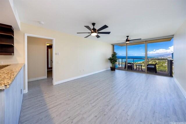 1551 Ala Wai Blvd Unit 2903, Honolulu, HI 96815 - unfurnished living room with expansive windows, wood finished floors, baseboards, and ceiling fan