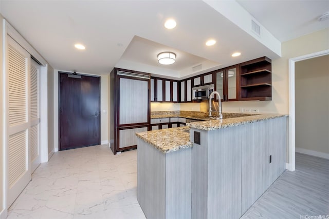 1551 Ala Wai Blvd Unit 2903, Honolulu, HI 96815 - kitchen featuring a peninsula, stainless steel microwave, visible vents, baseboards, and open shelves