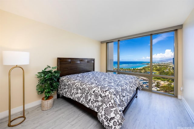 1551 Ala Wai Blvd Unit 2903, Honolulu, HI 96815 - bedroom with baseboards, expansive windows, wood finished floors, and a water view