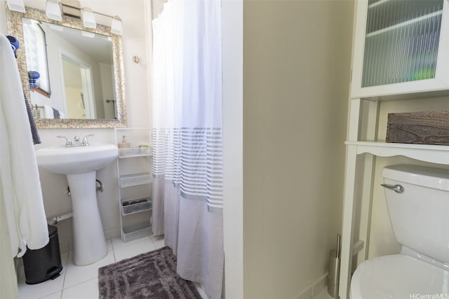 134 Kapahulu Ave Unit 617, Honolulu, HI 96815 - bathroom with tile patterned floors, toilet, and a sink