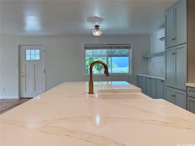 47-104 Hunaahi St, Kaneohe, HI 96744 - kitchen featuring plenty of natural light, ornamental molding, open shelves, a wall mounted air conditioner, and light stone countertops