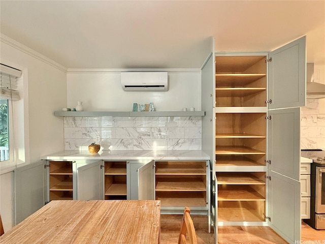 47-104 Hunaahi St, Kaneohe, HI 96744 - bar featuring a wall unit AC, electric stove, light wood-type flooring, backsplash, and wall chimney exhaust hood