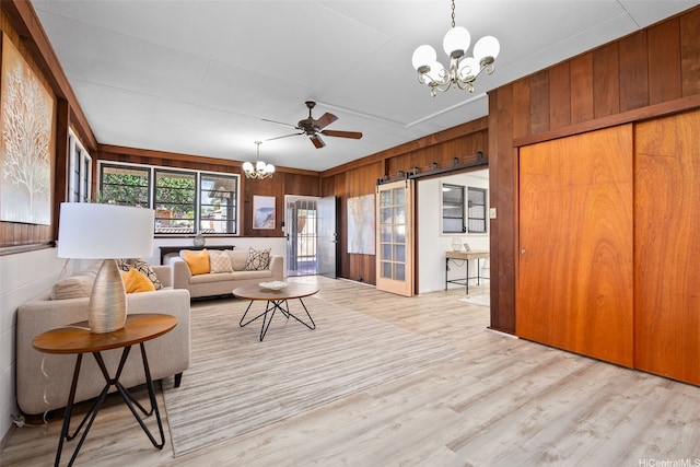 1230 Hoohulu St, Pearl City, HI 96782 - living room with a chandelier, light wood-style floors, wooden walls, and ceiling fan