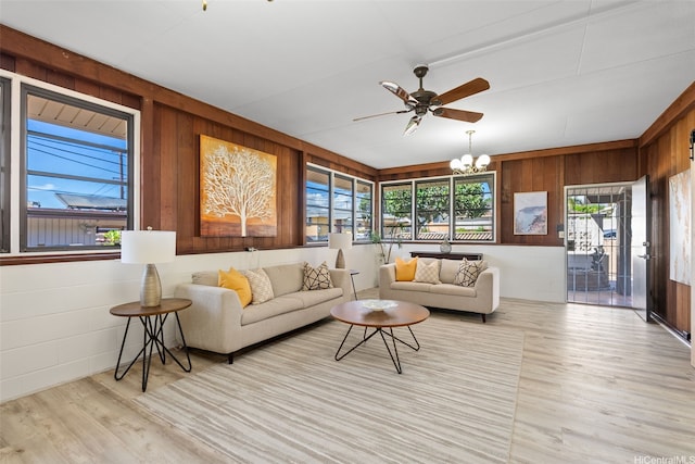 1230 Hoohulu St, Pearl City, HI 96782 - living area featuring wood finished floors, a chandelier, a ceiling fan, and wooden walls