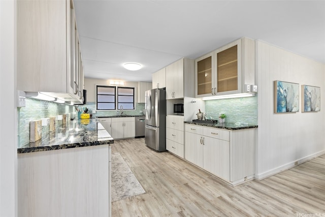 1230 Hoohulu St, Pearl City, HI 96782 - kitchen with appliances with stainless steel finishes, light wood-style flooring, tasteful backsplash, dark stone countertops, and glass insert cabinets