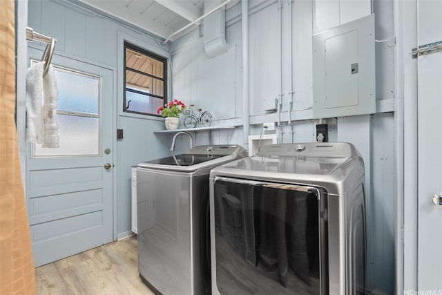 1230 Hoohulu St, Pearl City, HI 96782 - laundry area with electric panel, cabinet space, washing machine and dryer, and light wood-type flooring