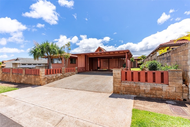 94-441 Kauopua St, Mililani, HI 96789 - view of front of house featuring board and batten siding, concrete driveway, a fenced front yard, and a carport