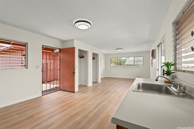 94-441 Kauopua St, Mililani, HI 96789 - kitchen featuring a sink, light wood finished floors, baseboards, and open floor plan