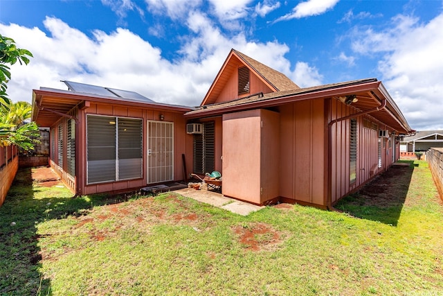 94-441 Kauopua St, Mililani, HI 96789 - rear view of house featuring an AC wall unit and board and batten siding