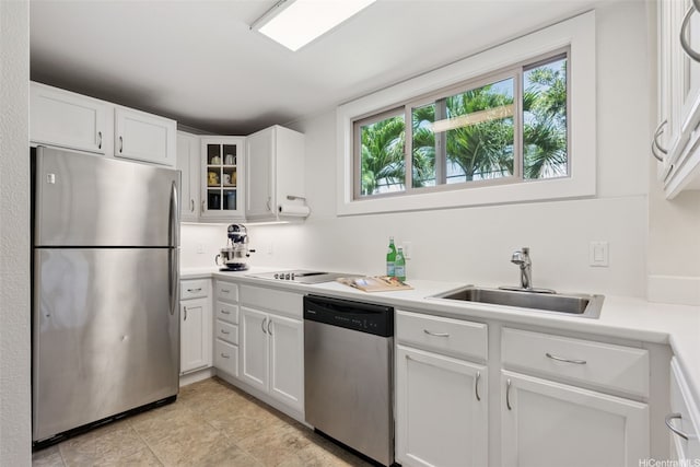 3750 Kaimuki Ave, Honolulu, HI 96816 - kitchen with stainless steel appliances, white cabinetry, light countertops, glass insert cabinets, and light tile patterned floors