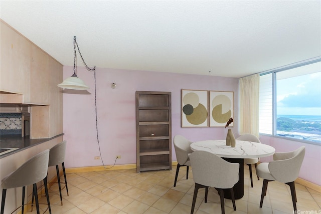 46-255 Kahuhipa St Unit 1001, Kaneohe, HI 96744 - dining space with light tile patterned floors, baseboards, and a textured ceiling