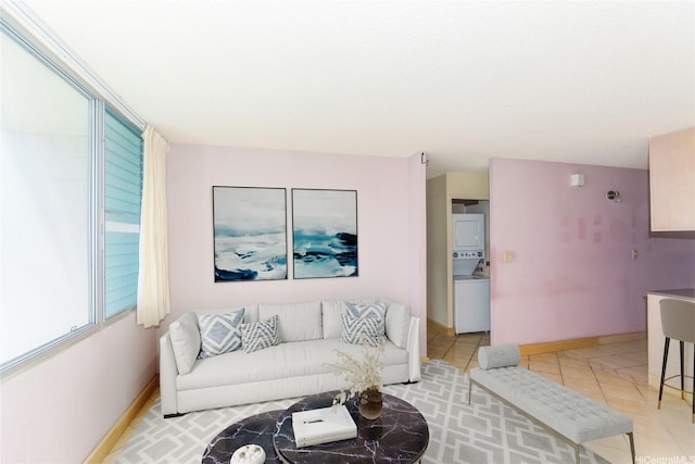46-255 Kahuhipa St Unit 1001, Kaneohe, HI 96744 - living area featuring baseboards, stacked washer and clothes dryer, and light tile patterned flooring