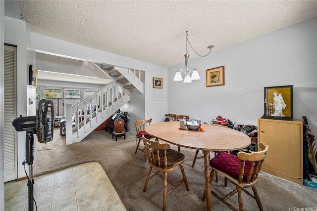 carpeted dining space with a textured ceiling, a chandelier, and stairway