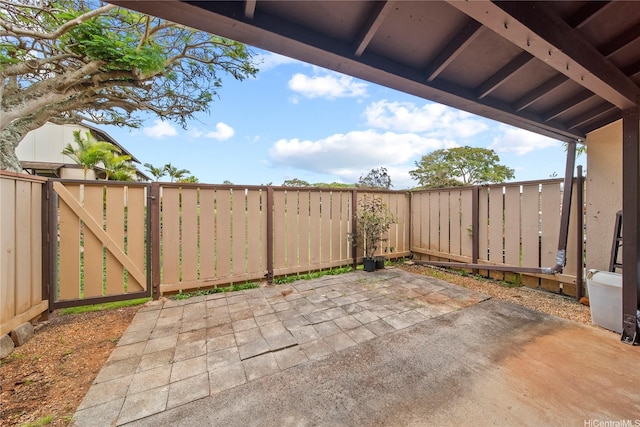 view of patio featuring a fenced backyard and a gate