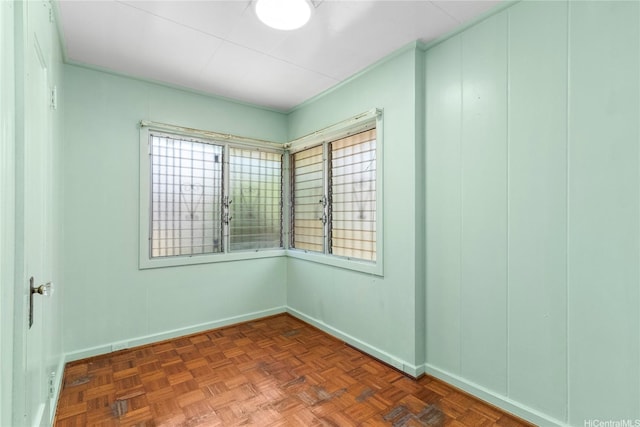 unfurnished room with baseboards