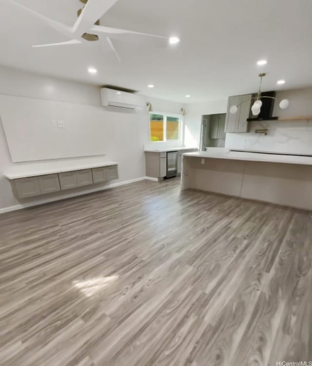 362 Waiopua Pl, Honolulu, HI 96825 - unfurnished living room with a wall mounted AC, wood finished floors, baseboards, recessed lighting, and ceiling fan