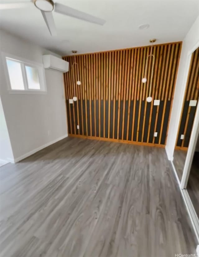 362 Waiopua Pl, Honolulu, HI 96825 - below grade area with a wall mounted air conditioner, wood finished floors, and baseboards