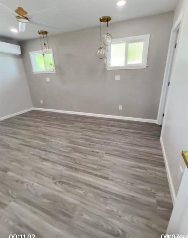 362 Waiopua Pl, Honolulu, HI 96825 - unfurnished dining area featuring a wall mounted air conditioner, baseboards, wood finished floors, and recessed lighting