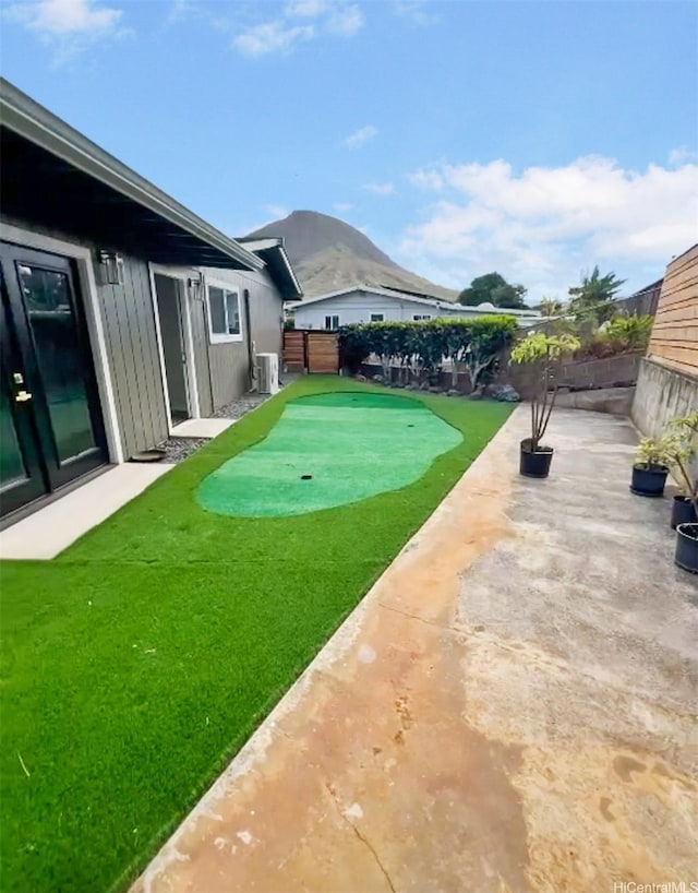 362 Waiopua Pl, Honolulu, HI 96825 - fenced backyard with a putting area, a patio area, and central AC unit