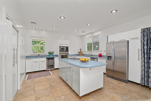 2107 Makanani Dr, Honolulu, HI 96817 - kitchen featuring wine cooler, appliances with stainless steel finishes, visible vents, and a healthy amount of sunlight