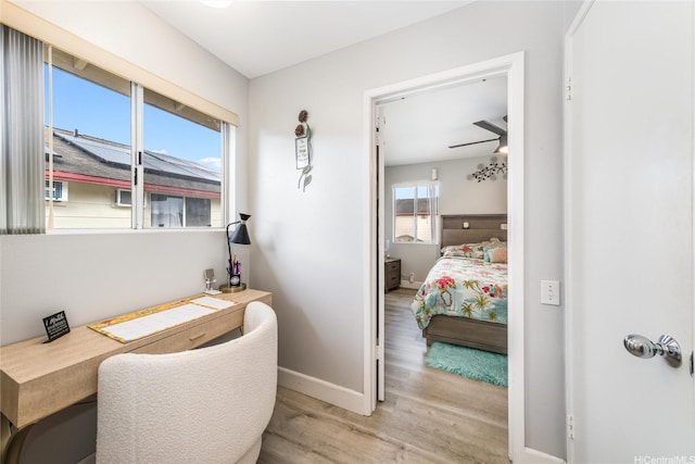 interior space with baseboards and wood finished floors