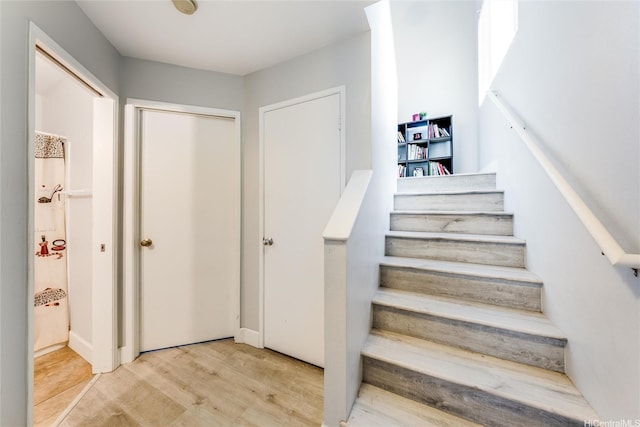 stairs featuring wood finished floors