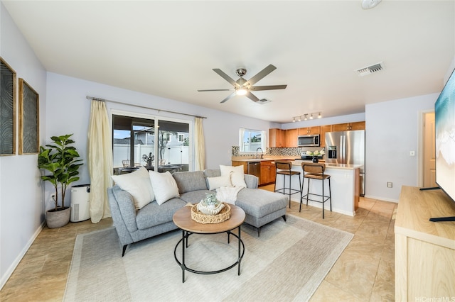 87-1801 Mokila St, Waianae, HI 96792 - living area with track lighting, baseboards, ceiling fan, and visible vents
