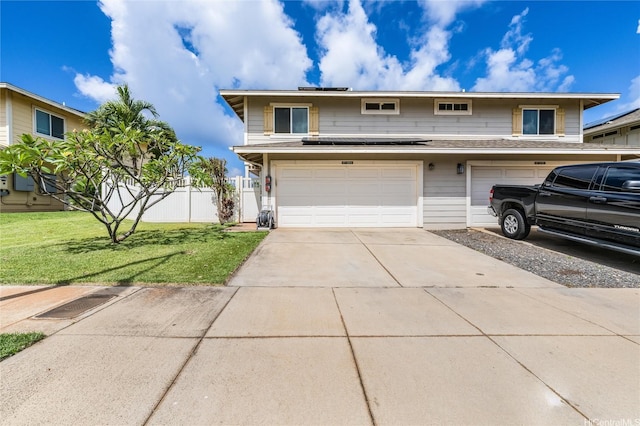 87-1801 Mokila St, Waianae, HI 96792 - traditional-style home with concrete driveway, an attached garage, and a front lawn