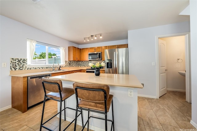 87-1801 Mokila St, Waianae, HI 96792 - kitchen featuring light countertops, brown cabinets, tasteful backsplash, a sink, and stainless steel appliances
