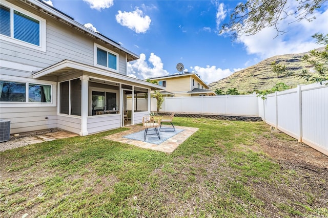 87-1801 Mokila St, Waianae, HI 96792 - view of yard with a sunroom, central AC, a mountain view, a fenced backyard, and a patio