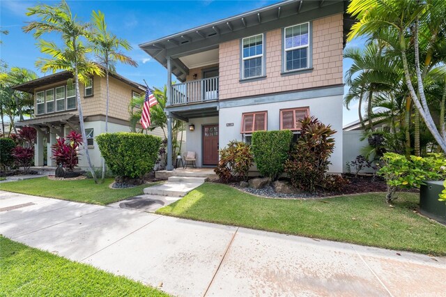 91-1180 Waiemi St, Ewa Beach, HI 96706 - view of front of home featuring a balcony, a front lawn, and stucco siding