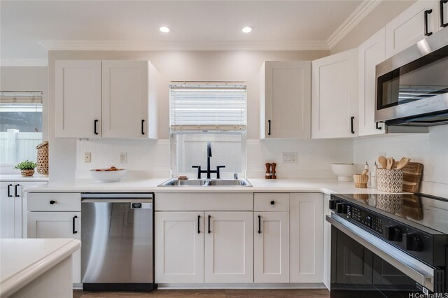 91-1180 Waiemi St, Ewa Beach, HI 96706 - kitchen with stainless steel appliances, a sink, decorative backsplash, ornamental molding, and white cabinetry