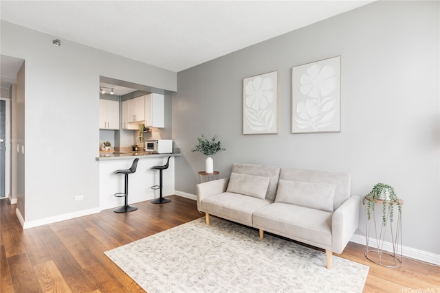 876 Curtis St Unit 3208, Honolulu, HI 96813 - living room featuring wood finished floors and baseboards