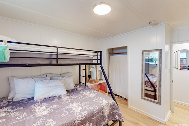 bedroom featuring baseboards and wood finished floors