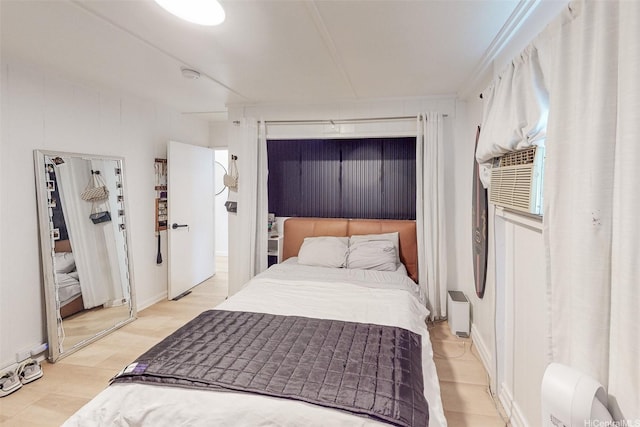 bedroom with light wood-style floors and cooling unit