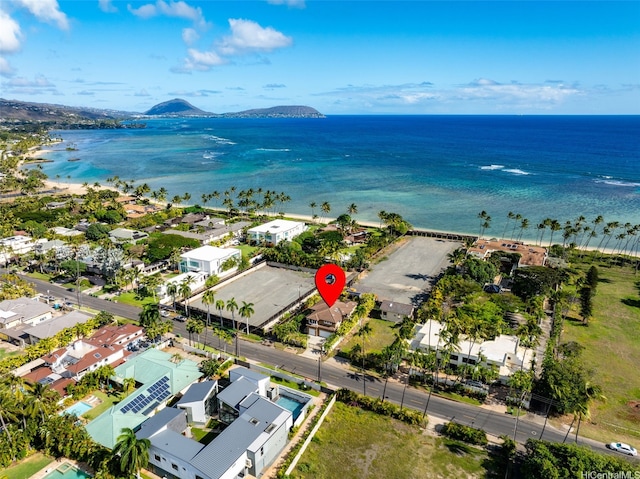 bird's eye view with a beach view, a water and mountain view, and a residential view
