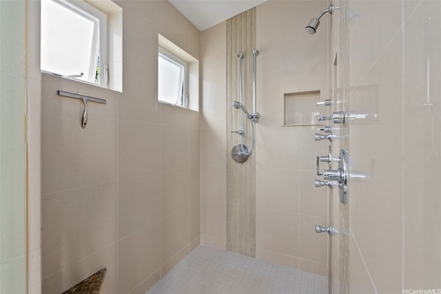 bathroom with a tile shower